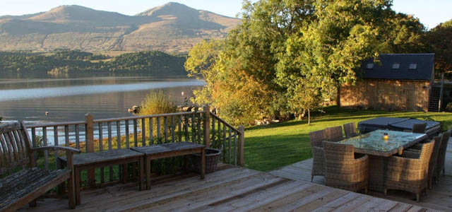 out door sitting and dining area overlooking loch