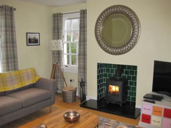 cosy sittingroom with wood burning stove