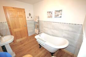 bathroom with roll top bath