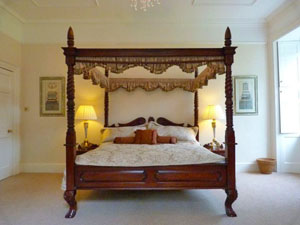 master bedroom with romantic four poster bed