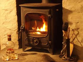 Stone fire place Antlers above wood burning stove