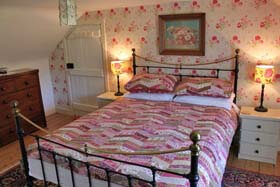 double bedroom with patch work quilt