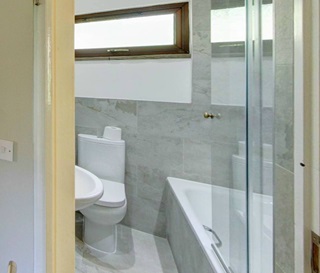 bathroom with shower over bath